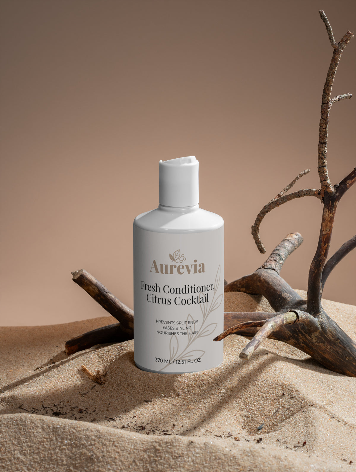 Aurevia Fresh Conditioner Citrus Cocktail bottle on sand with driftwood, nourishes hair, prevents split ends