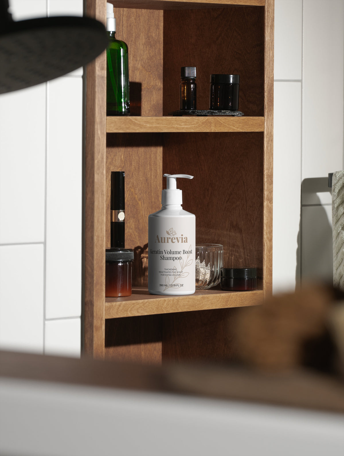 Aurevia Keratin Volume Boost Shampoo on wooden bathroom shelf with other hair care products