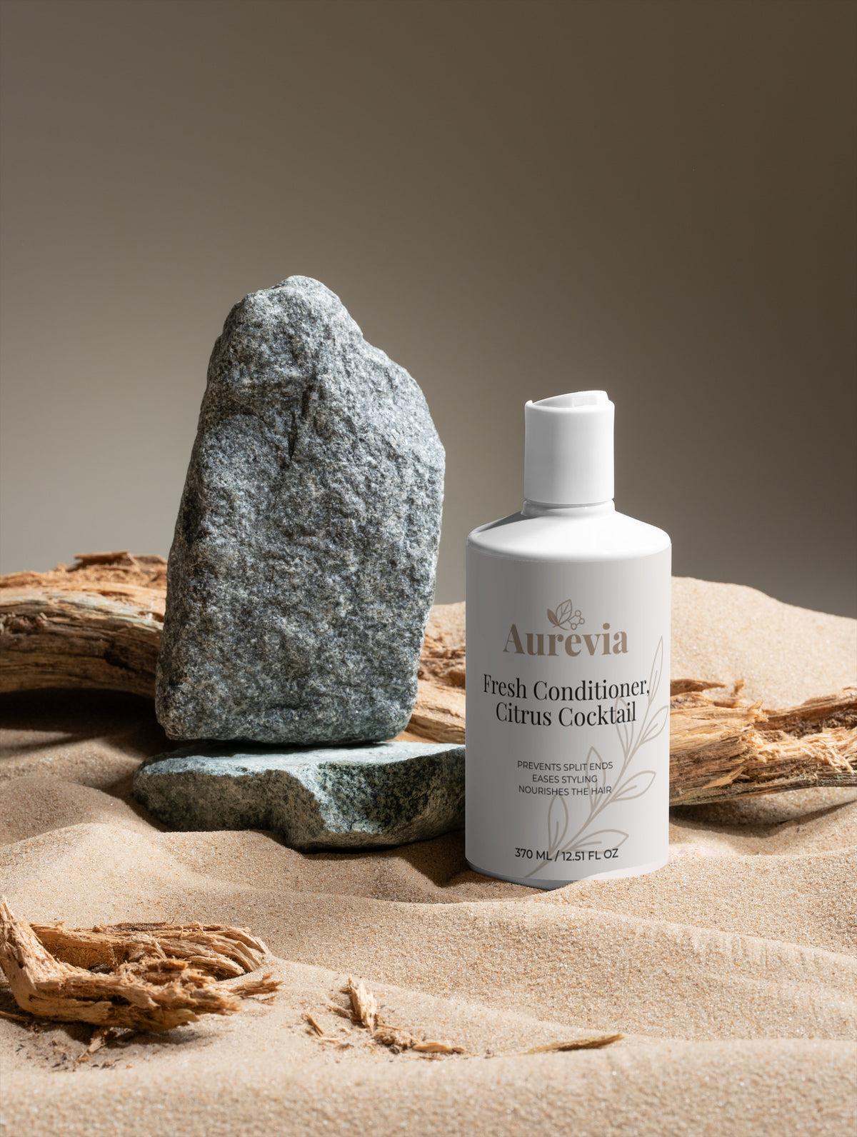 Fresh Conditioner Citrus Cocktail bottle on sand with rocks, prevents split ends & nourishes hair