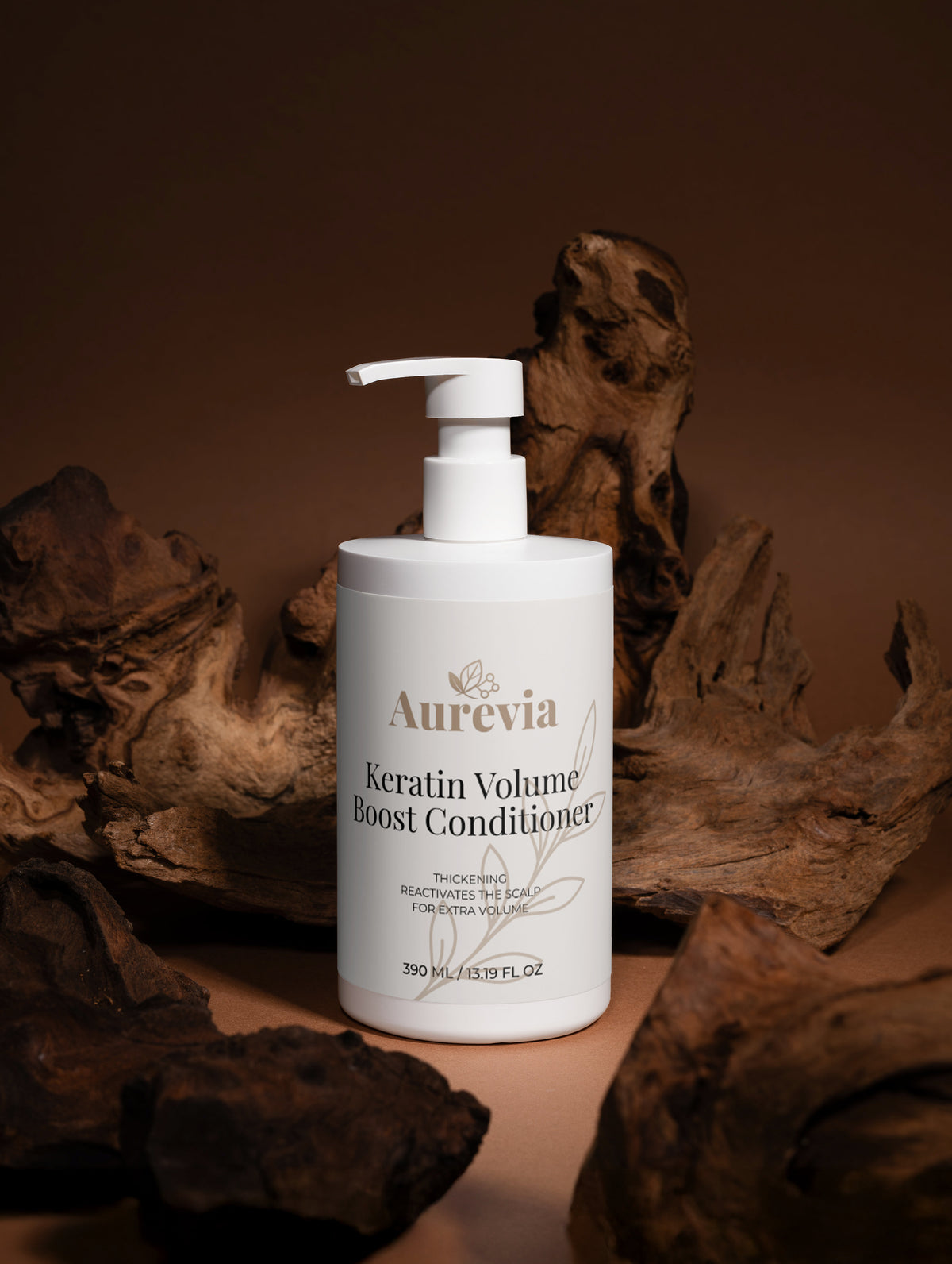 Aurevia Keratin Volume Boost Conditioner bottle with pump, surrounded by rustic driftwood, for thickening and scalp care.