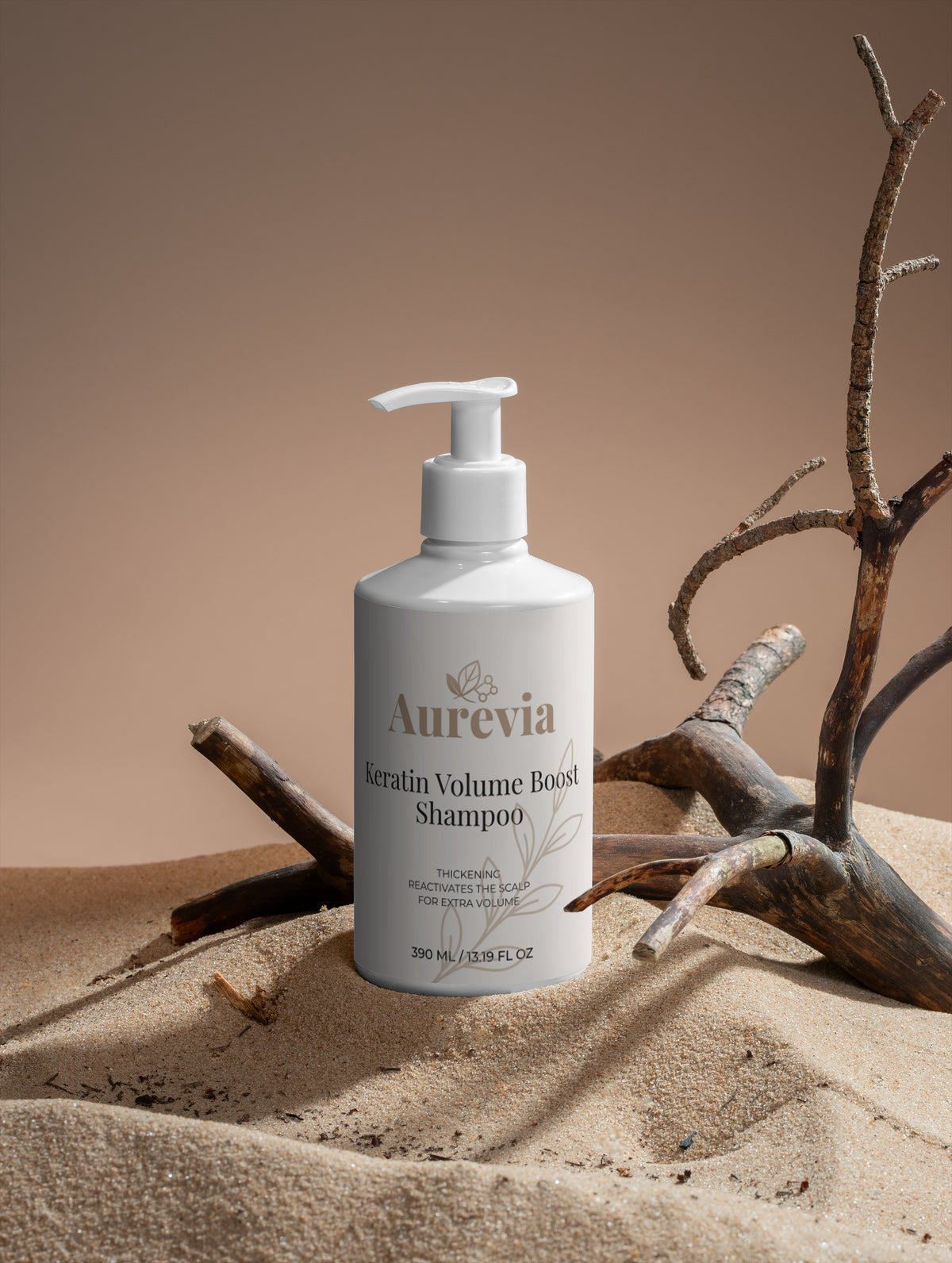 Keratin Volume Boost Shampoo bottle on sand with driftwood, for thickening and scalp revitalization