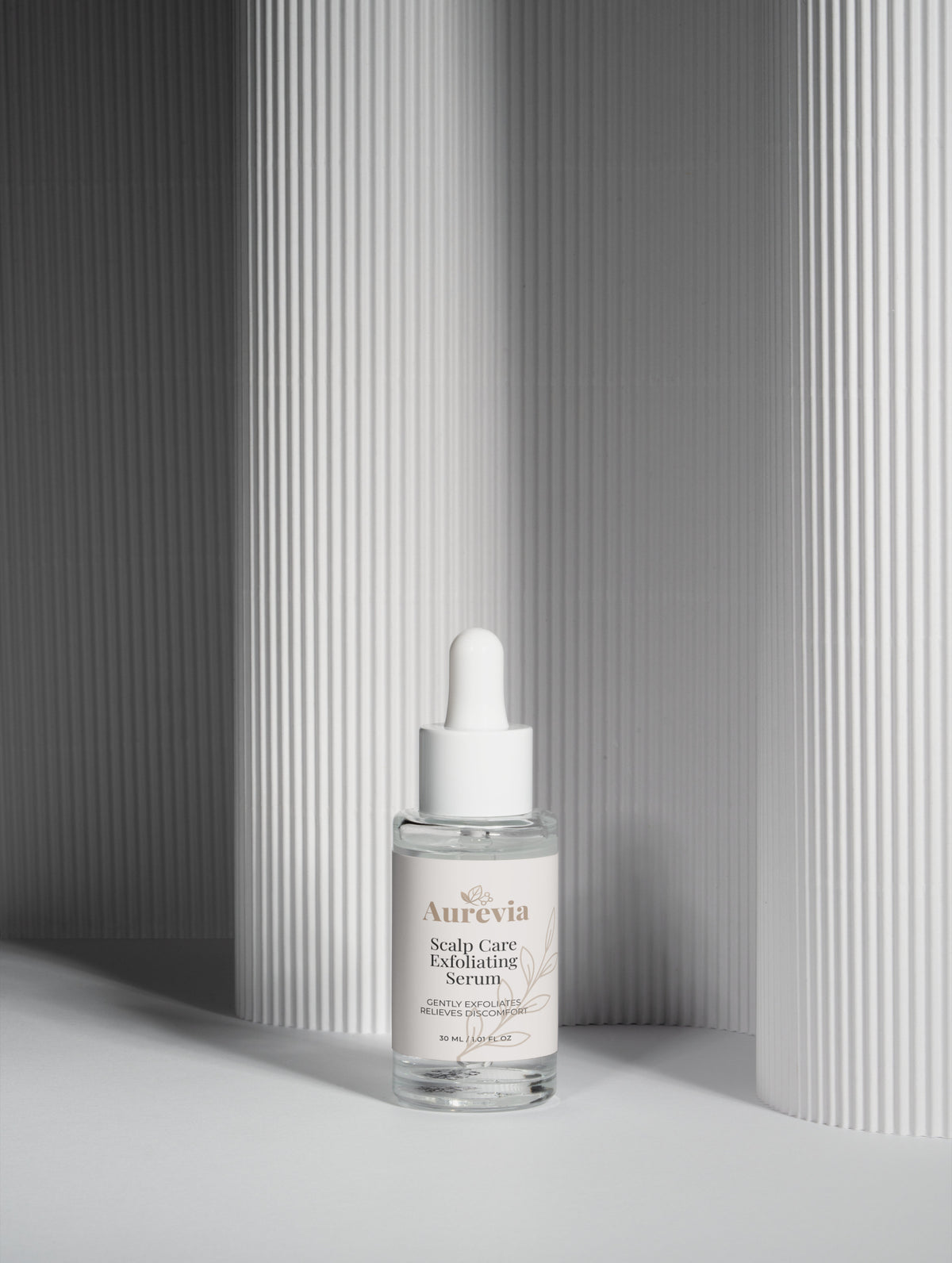 Aurevia Scalp Care Exfoliating Serum bottle with dropper, gently exfoliates for scalp relief, minimalist white background