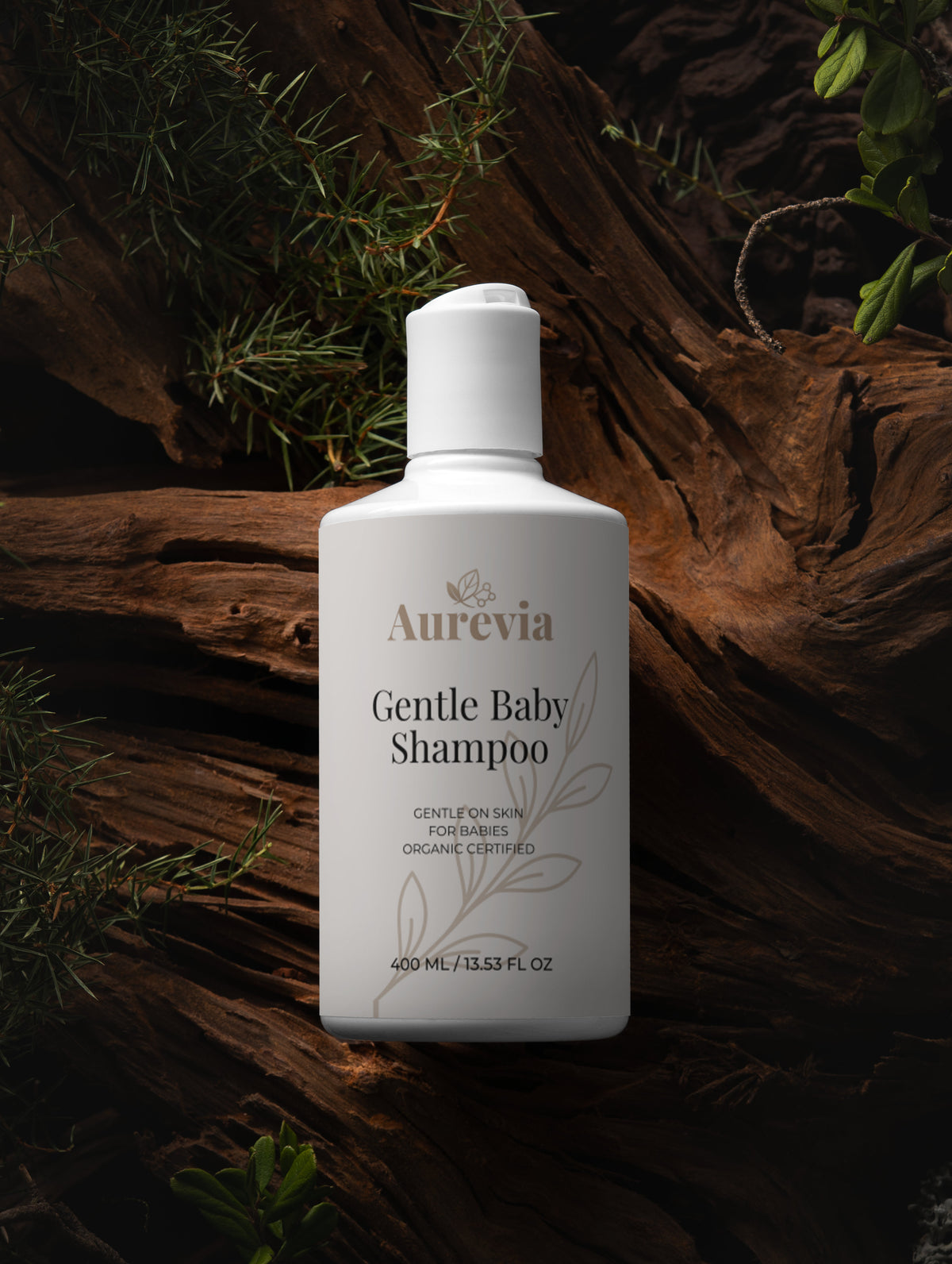 Gentle baby shampoo bottle on rustic wood with greenery, organic certified for sensitive skin